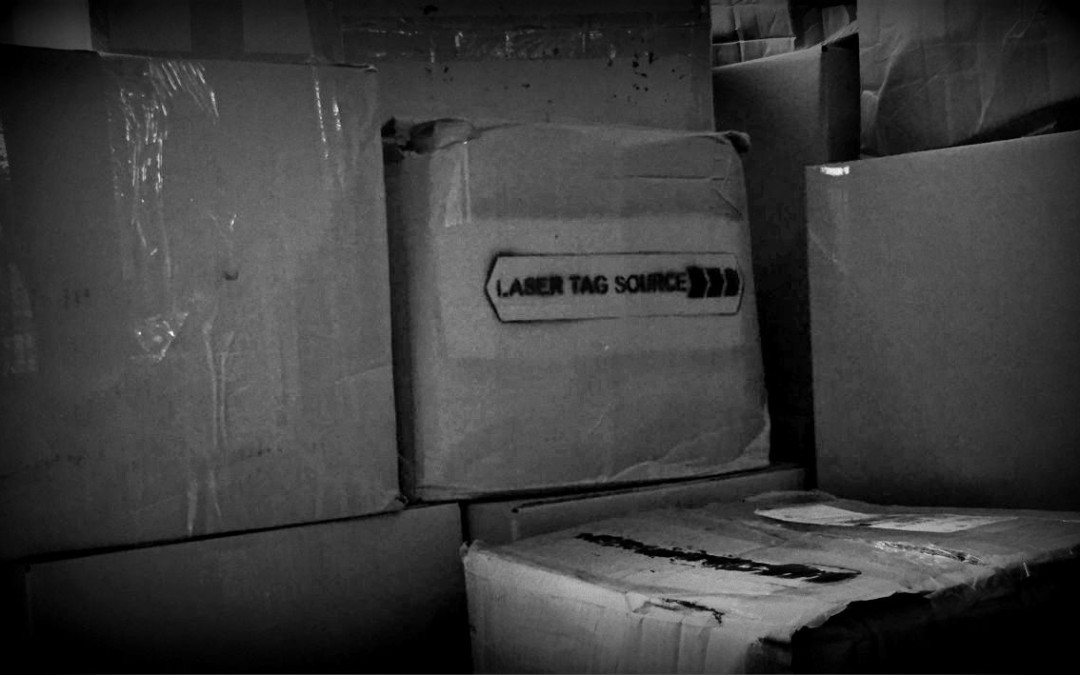 cardboard boxes stacked with logo painted on side