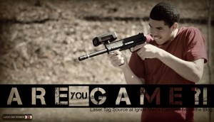 teenage boy playing laser tag with tippmann gun and text asking Are You Game at bottom