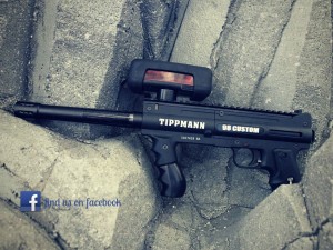 Tippmann laser tag gun against rocks